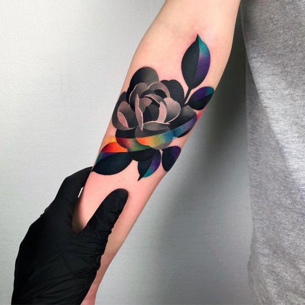 Stylized rose with rainbow stripe tattoo