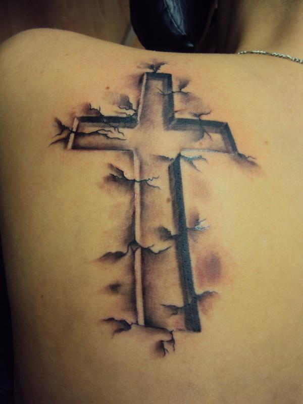 decorative swirls around cross tattoo; cross