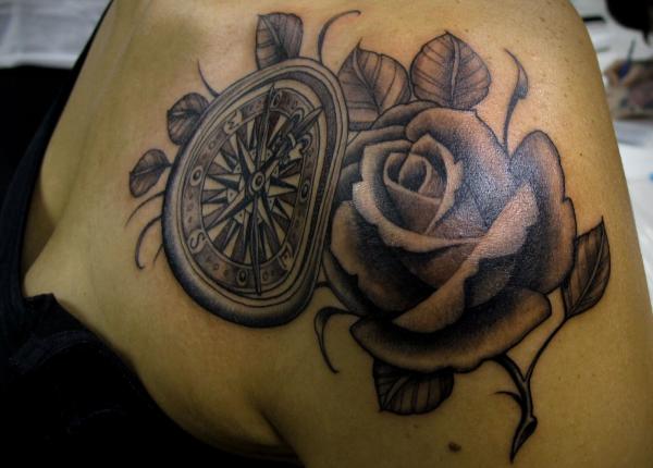 Black and grey compass and rose tattoo on shoulder