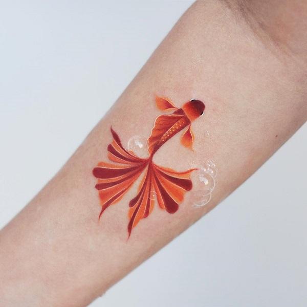 Tiny fish tattoo placed on the wrist.