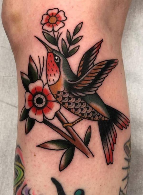 Micro-realistic hummingbird tattoo placed on the
