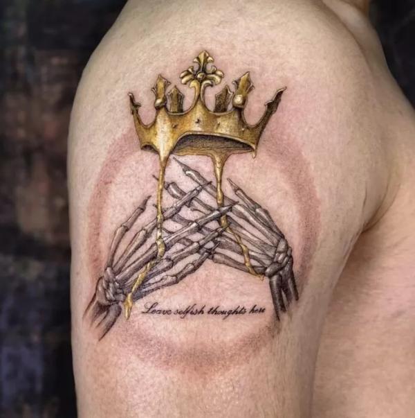 Crown tattoo on the inner forearm.