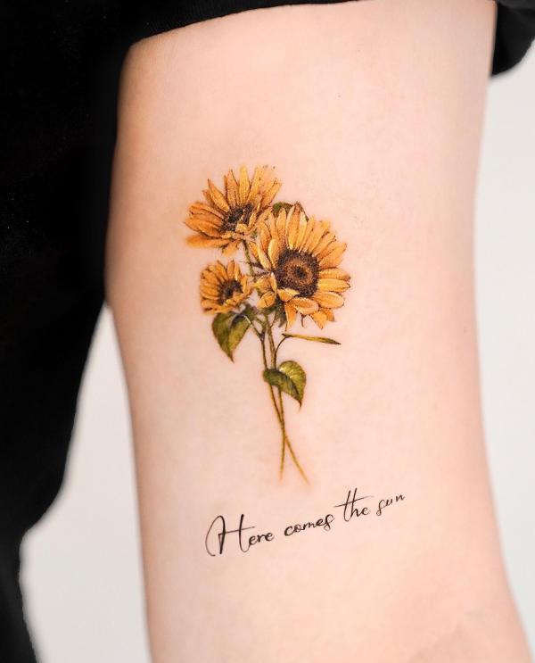 A summery tattoo design of a sunflower on sun kissed skin is a perfect  symbol of joy and fun | Ratta Tattoo