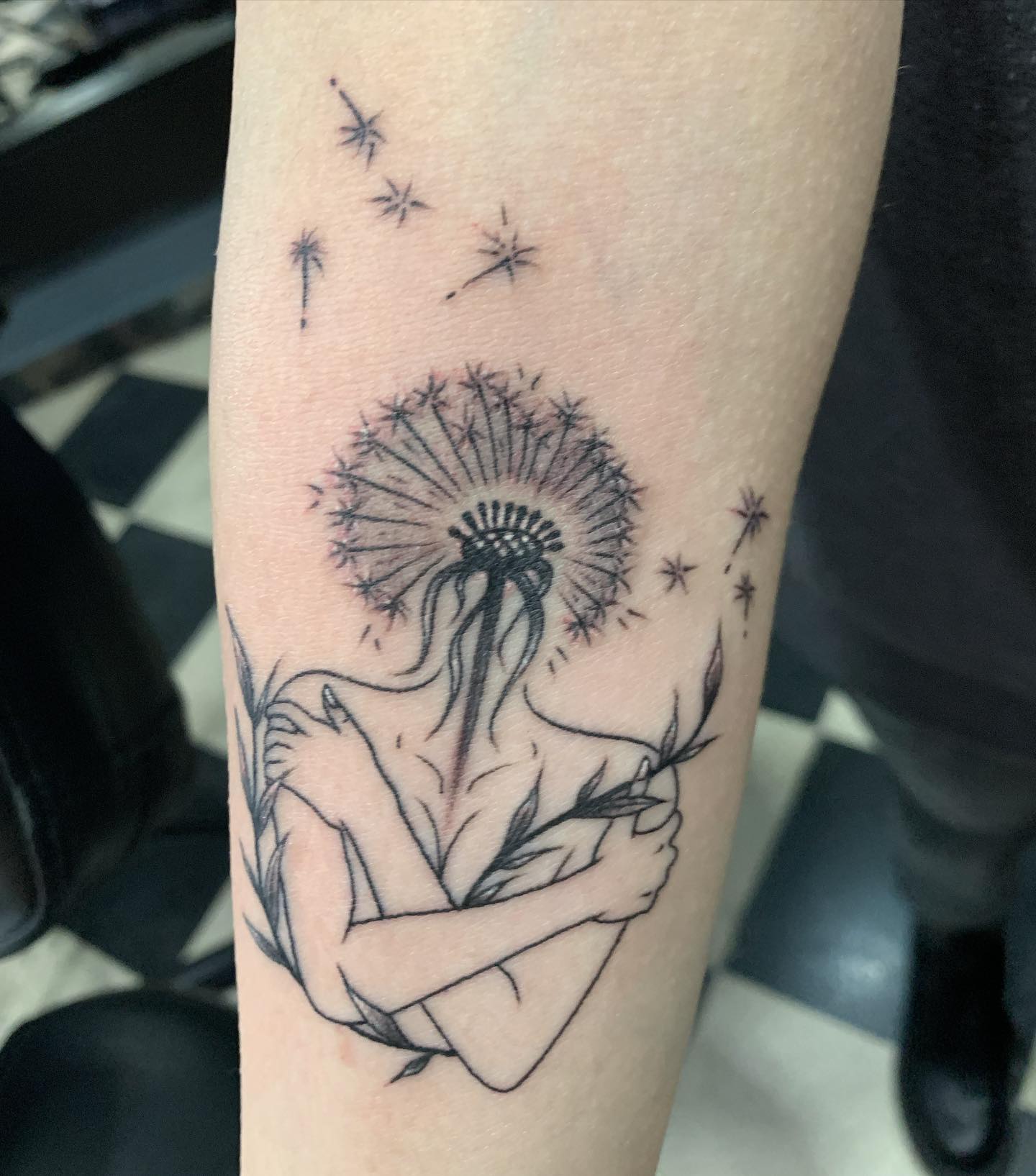 Dandelion seed tattoo located on the wrist, fine line