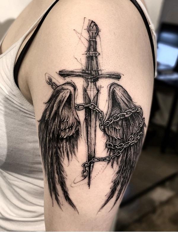 cross and angel wings on arm