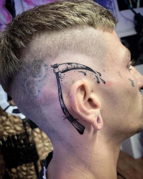 scythe tattoo above ear