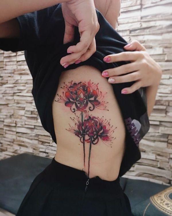 Red Spider Lily tattoo on the inner forearm