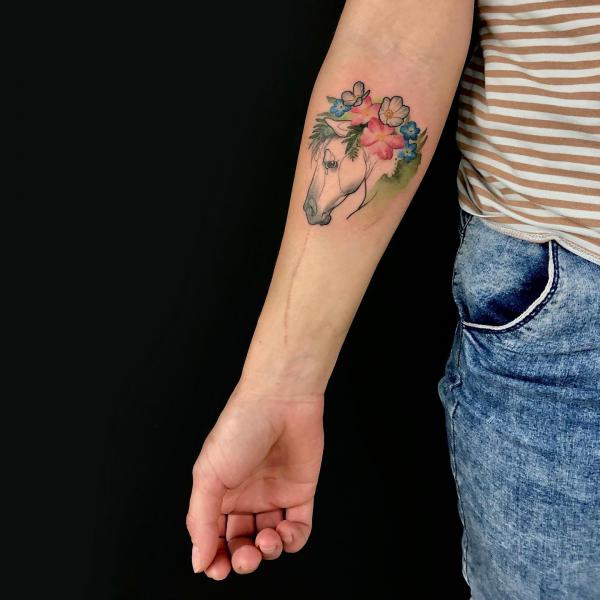 Horseshoe & Flowers Tattoo by Irit Gamburg