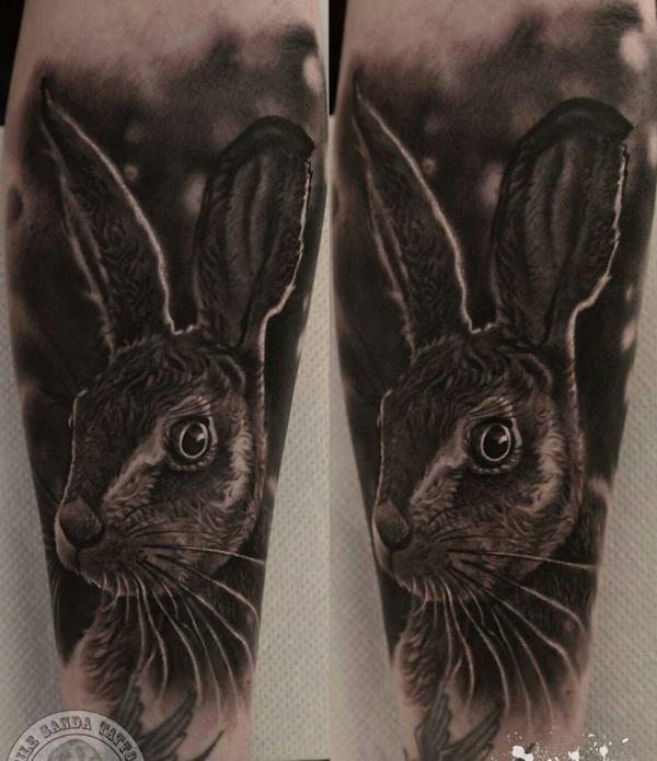 Micro-realistic rabbit tattoo on the inner arm.