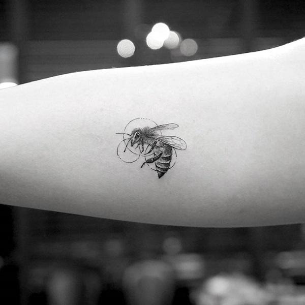 Microrealistic bee tattoo on the inner forearm
