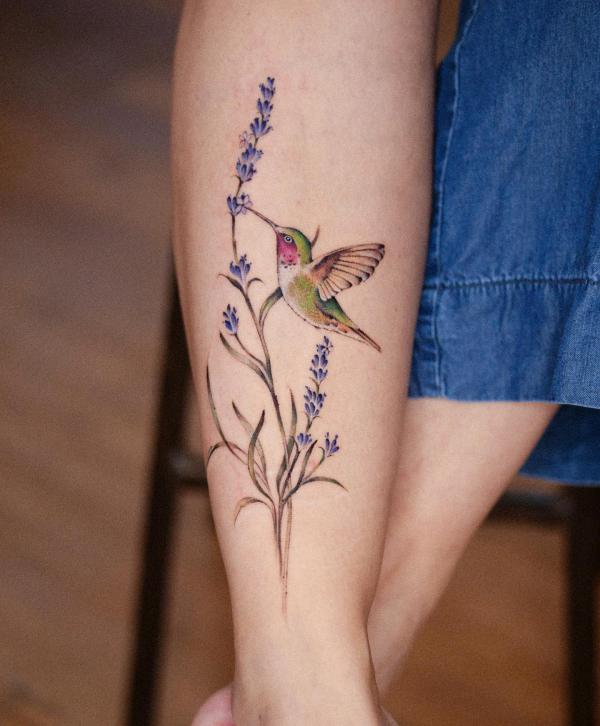 Fine line lavender tattoo on the inner forearm.
