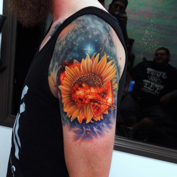 Firing sunflower and galaxy shoulder tattoo
