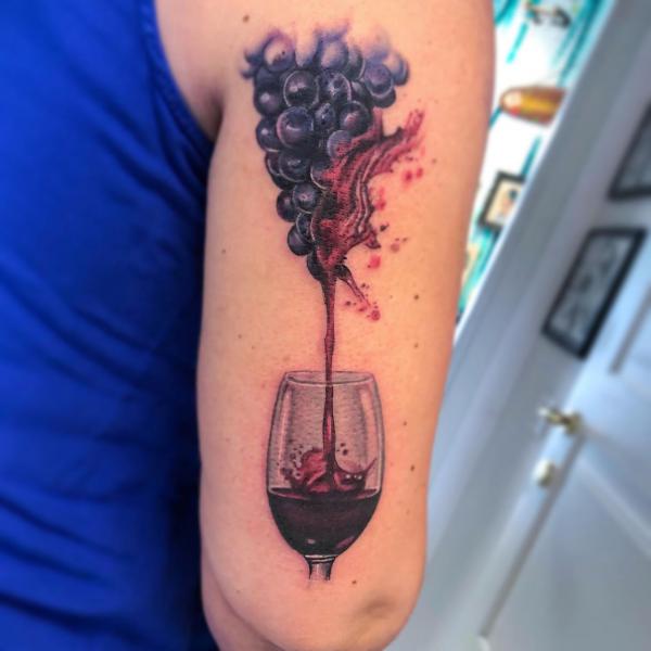 One line wine glass tattoo on the inner forearm.