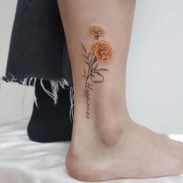 Marigold & Larkspur flowers by xedgex6 at Anchors & Arrows Tattoos.. first  one in 8 years and he's done all my others! : r/traditionaltattoos