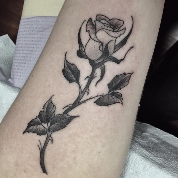 Small rose with thorns infinity tattoo