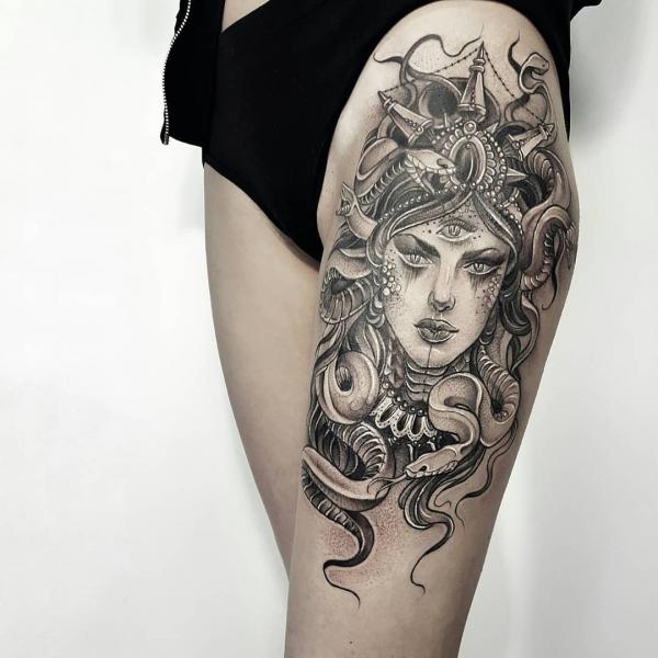 Black and grey Medusa with eye tattoo on thigh