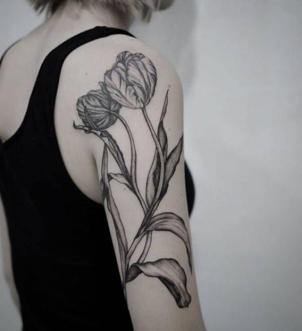 Black and grey tulip back of arm tattoo