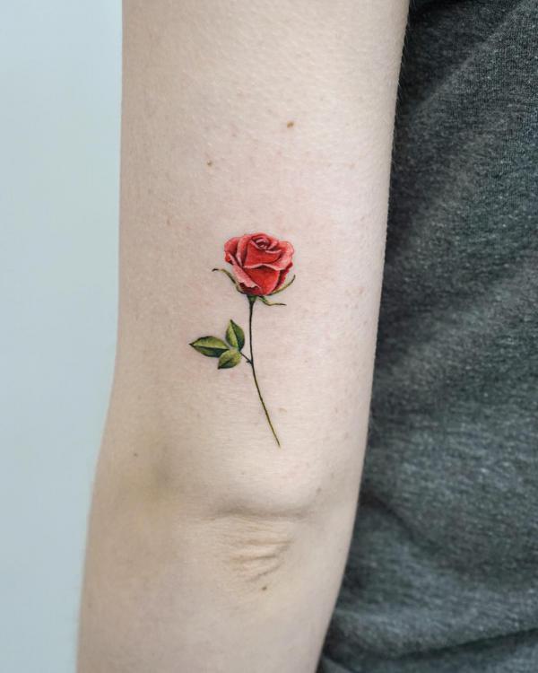 Small rose back of arm tattoo