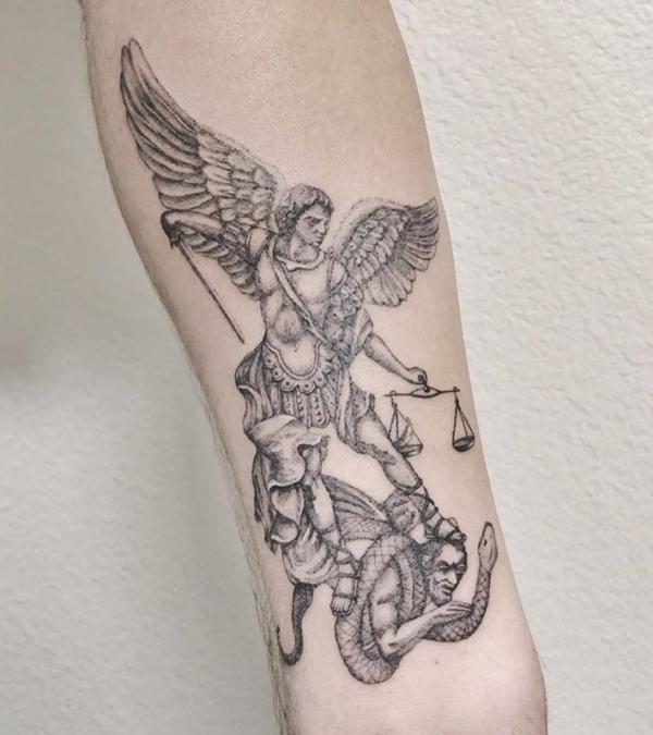Archangel Michael tattoo on the right side ribcage.