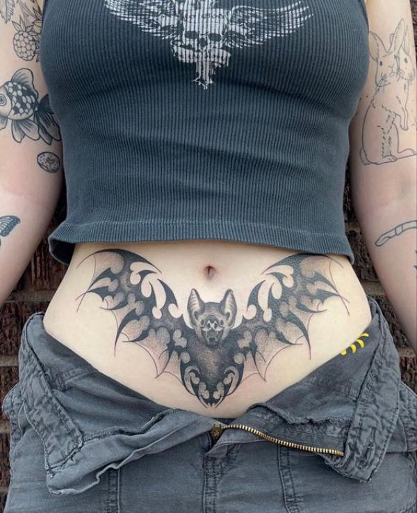 Black and grey bat tummy tattoo