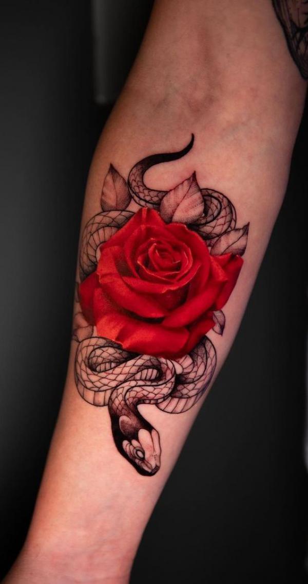 Rose with snake forearm tattoo
