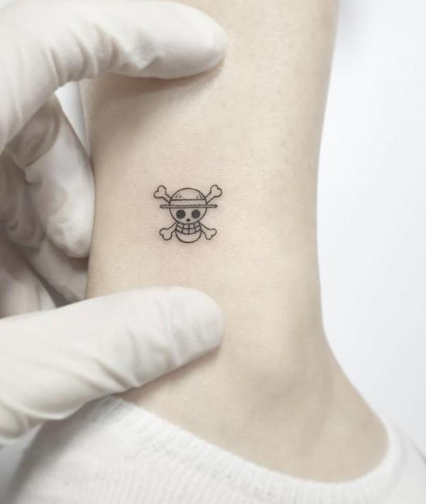 Minimalist one piece skull tattoo