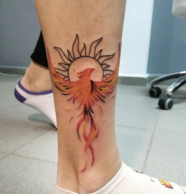 phoenix sun tattoo on lower leg