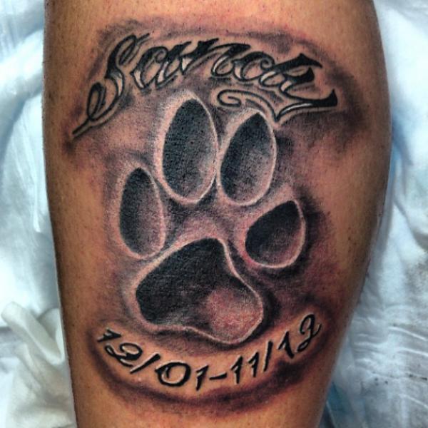 Lion king paw print with date tattoo