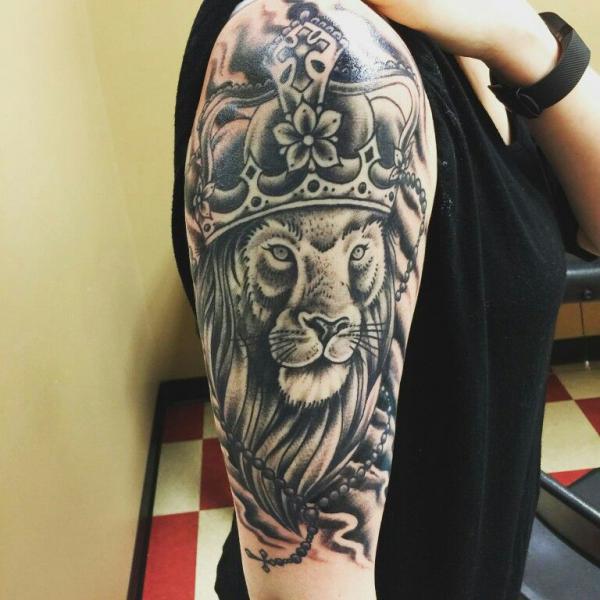 Lion king with crown and rosary tattoo