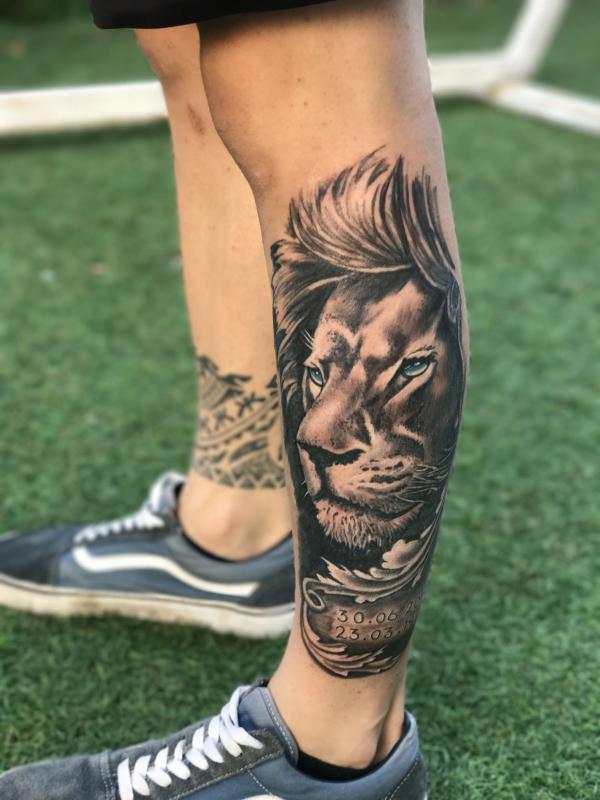 Lion king with dates tattoo lower leg